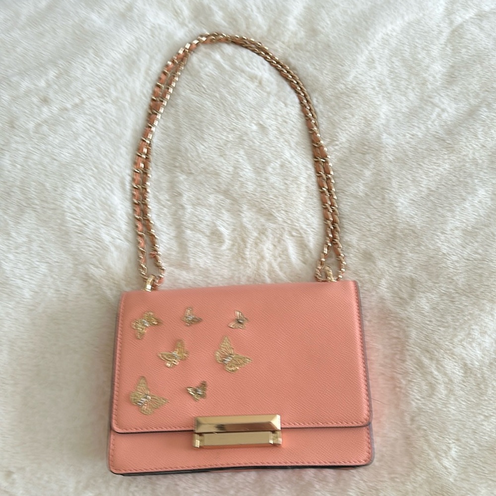 Pink purse with gold butterflies on it